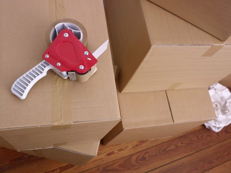 Fragile household items being wrapped and organised for a move